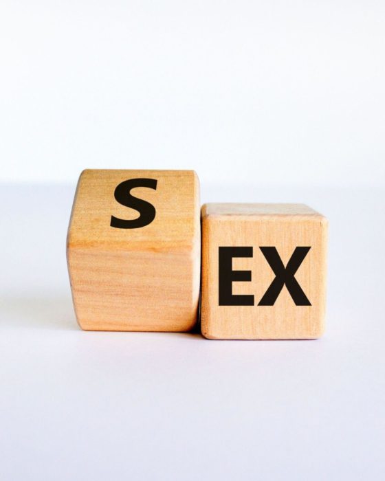 2EE433H Sex with an Ex symbol. Turned a cube and changed the word 'ex' to 'sex'. Beautiful white table, white background. Psychology and Sex with an Ex concep