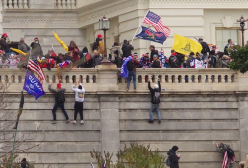 2K9T00T Pro-Trump rioters climb a wall on the U.S. Capitol facade during the January 6, 2021, insurrection.