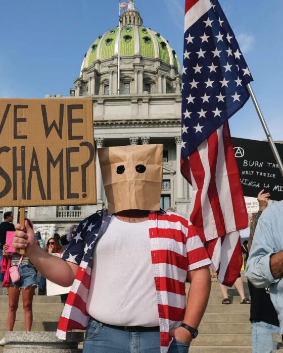 HARRISBURG, PA, AUGUST 2, 2025. DEMONSTRATORS HOLD PLACARDS AT THE ANTI-TRUMP “RAGE AGAINST THE REGIME” PROTEST AT THE PENNSYLVANIA CAPITOL IN HARRISBURG, PA. PHOTO BY SIPA USA/ALAMY.