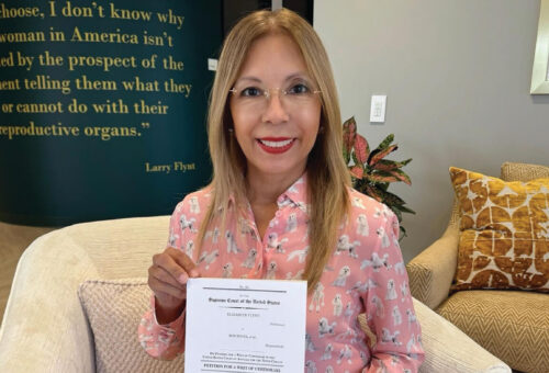 AT FMG HEADQUATERS, ELIZABETH FLYNT HOLDS THE PETITION FOR A WRIT OF CERTIORARI TO THE SUPREME COURT.